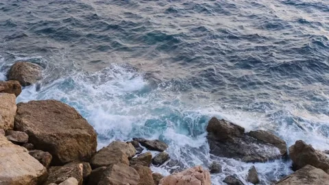 Ocean waves crashing and flowing on the coastline rocks, nature footage 4k. Stock Footage 228809062