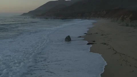 Ocean waves crashing on beach from drone Stock Footage 244936780