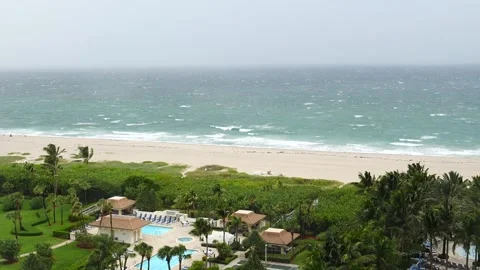 Ocean waves crashing on the beach during stormy weather slow motion Palm Beach Video stock 213129756