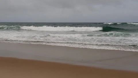 Ocean waves crashing on a cloudy gray day with copy space Stock Footage 307852431