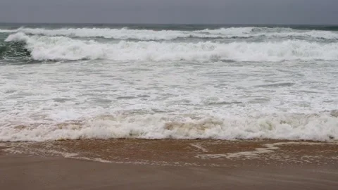 Ocean waves crashing on a cloudy gray day with copy space Stock Footage 307852443