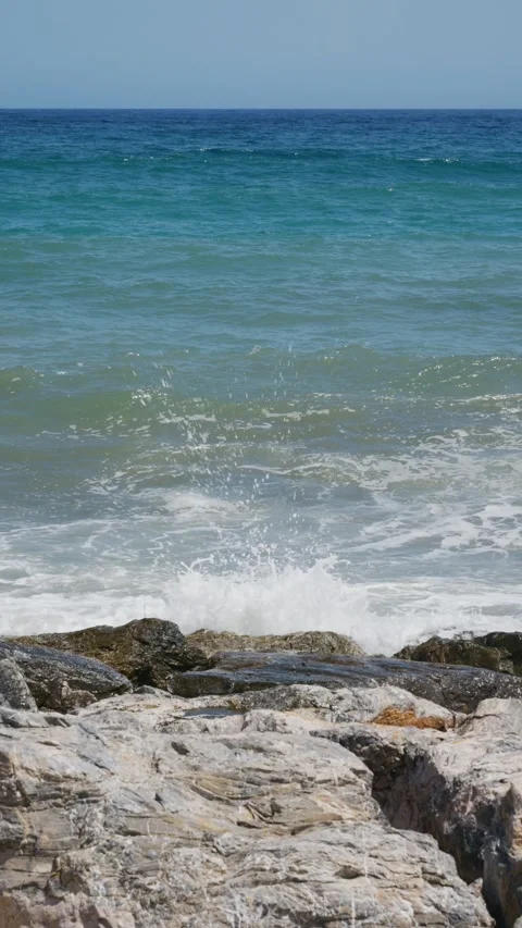 Ocean waves crashing on coastal rocks creating foam Stock Footage 337102002