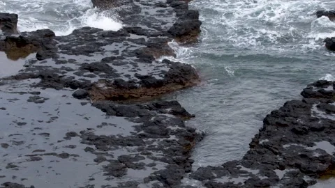 Ocean Waves Crashing Over Basalt Rock Tide Pools in Mornington Peninsula Stock Footage 345100370