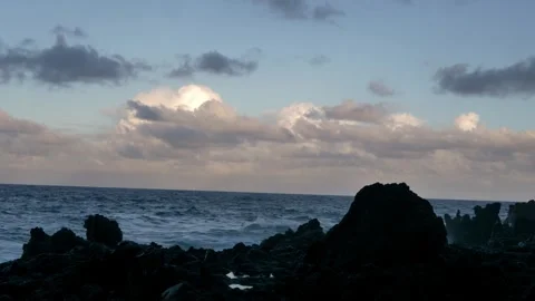 Ocean Waves Crashing Over Jagged Volcanic Rocks on Rocky Shore Vídeo Stock 304250848