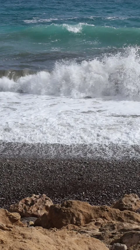 Ocean Waves Crashing On Pebble Beach Vertical Video 스톡 동영상 345087112
