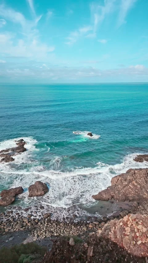 Ocean waves crashing on rocks from cliff Stock Footage 294272014