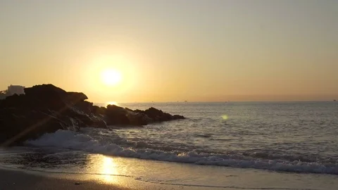 Ocean waves crashing onto the rocks in the sunset Stock Footage 81764971