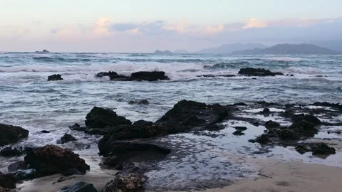 Ocean waves crashing on rocks under a sunset in Oahu Hawaii Stock Footage 279909738
