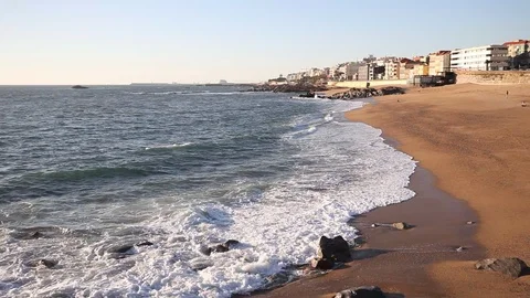 Ocean waves crashing on sandy beach on a sunny day with, Portugal, Porto dist Stock Footage 105656365