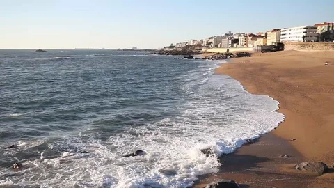 Ocean waves crashing on sandy beach on a sunny day, Portugal, Porto district. Stock Footage 109545975