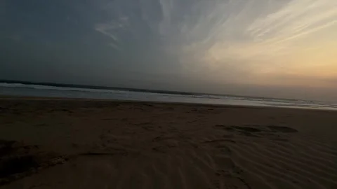 Ocean Waves Crashing on Sandy Beach at Golden Hour, Low Angle Tracking Shot Stock Footage 324772134