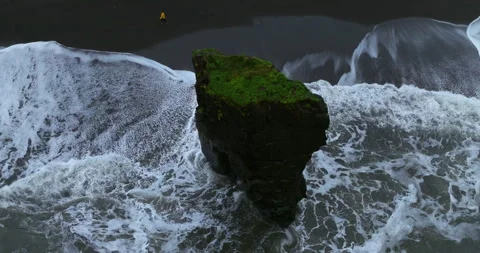 Ocean Waves Crashing On Sea Stack At Laekjavik Black Sand Beach In Video stock 268934564
