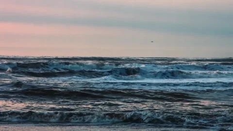 Ocean waves crashing on the shore during dusk long shot Stock Footage 342139029