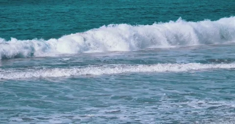 Ocean waves crashing on shore under bright sunlight Stock Footage 339519799