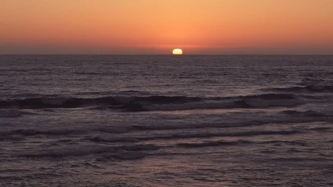 Ocean waves crashing in slow motion at sunset. Ocean, warm sky, no clouds. Video stock 88629419