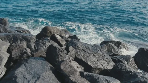 Ocean waves crashing on stone beach Stock Footage 70409278
