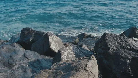 Ocean waves crashing on stone beach Video stock 70411697
