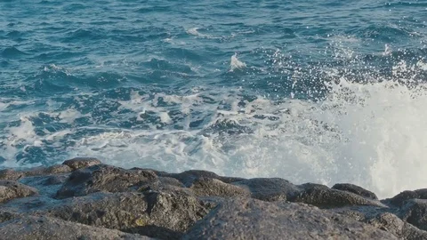 Ocean waves crashing on stone beach Stock Footage 70432523