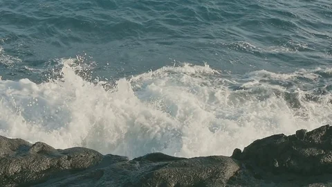 Ocean waves crashing on stone beach Stock Footage 70769223