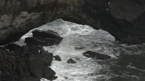 Ocean Waves Crashing Under the Dyrhólaey Sea Arch in Southern Iceland Stock Footage 339961432
