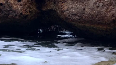 Ocean waves crashing under a rock formation in Oahu Hawaii Stock Footage 279909840