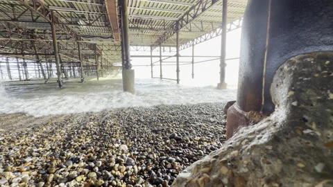 Ocean waves crashing under seaside pier 4K Stock Footage 338133611
