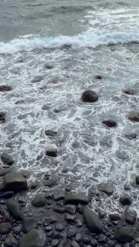 Ocean Waves Crashing on Volcanic Pebble Beach Stock Footage 340067426