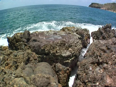 Ocean waves cut thru rocks FISHEYE Stock Footage 708928