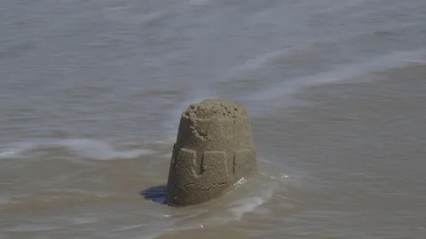 Ocean Waves Destorying Small Sandcastle on the Beach Video stock 74374581