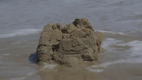 Ocean Waves Destroying Sandcastle on the Beach Video stock 74388029
