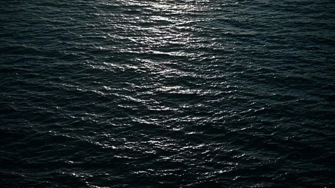 Ocean waves during sunset. Sun glitters on a water surface. Stock Footage 128900507