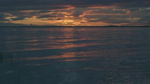 Ocean waves during twilight beneath a cloudy sky Stock Footage 137928684