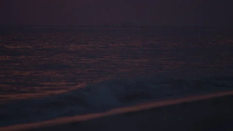 Ocean waves at dusk dark purple sunset in slowmotion Stock Footage 143980249