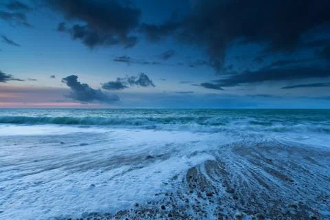 Ocean waves in dusk Stock Photos