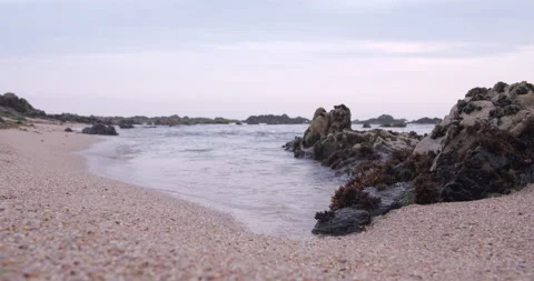 Ocean waves ebbing on the sandy shore at beach. Low angle close up Stock Footage 131766197