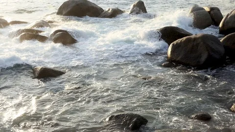 The ocean waves in the evening at the beach with many rocks Stock-Footage 107171104