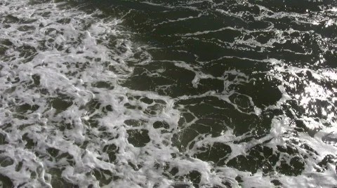 Ocean waves flow towards shore on sunny day (High Definition) Stock Footage 365024