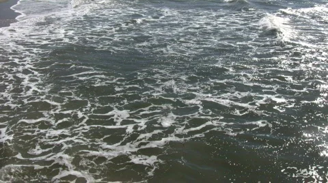 Ocean waves flow towards shore on sunny day (High Definition) Stock Footage 365025