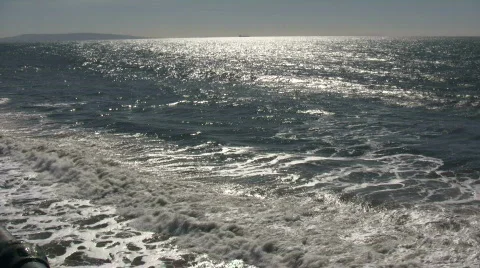 Ocean waves flow towards shore on sunny day (High Definition) Stock Footage 365053