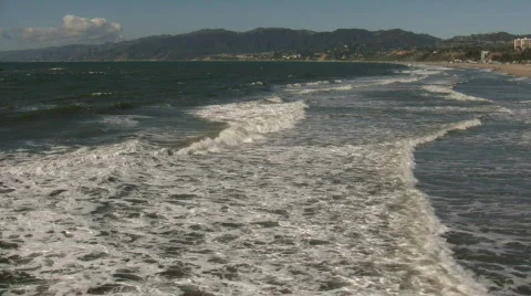 Ocean waves flow towards shore on sunny day (High Definition) Stock Footage 365055