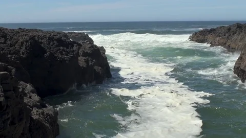 Ocean waves flowing into the Devil's Churn inlet Stock Footage 83023624