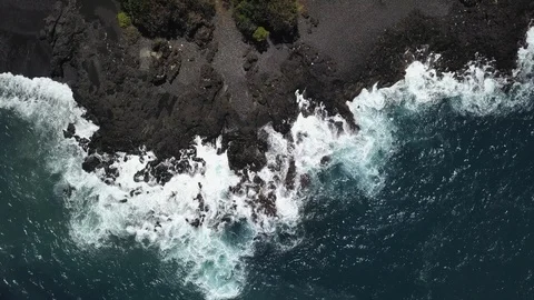 Ocean waves with foam beat against the stone shore on a wild beach. Stock Footage 106519721