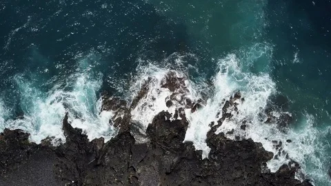 Ocean waves with foam beat against the stone shore on a wild beach. Stock Footage 106680967