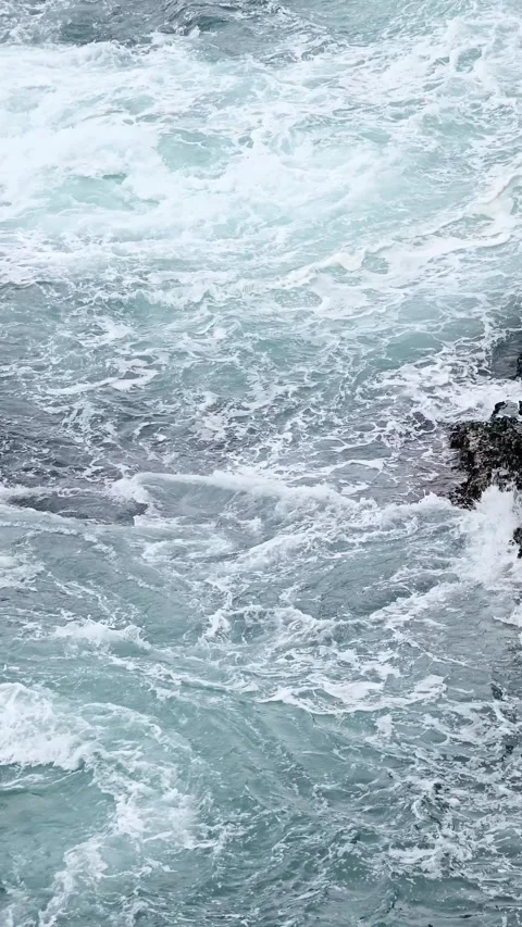 Ocean waves foaming between coastal rocks in slow motion Stock Footage 346543384