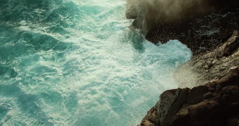 Ocean waves foaming splshing on rocky shore. Raging severe sea turquoise water Video stock 239091583