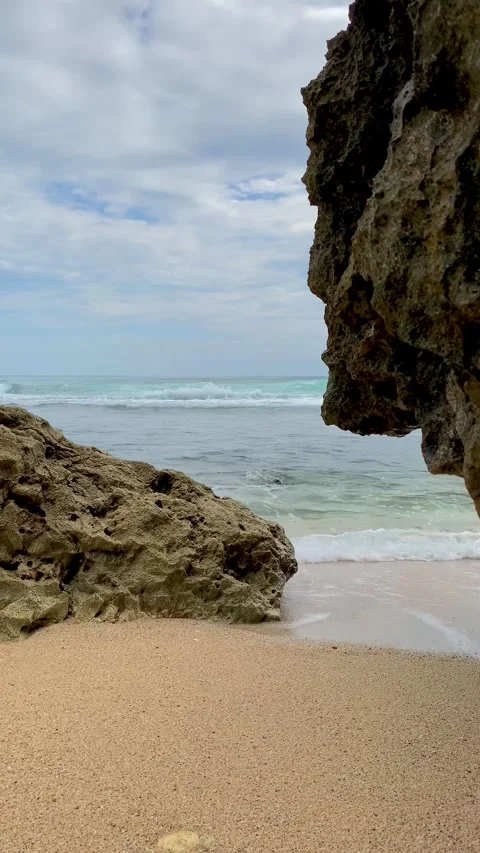 Ocean Waves Framed by Coastal Rock Formation at Ngobaran Beach Indonesia Stock Footage 337107861