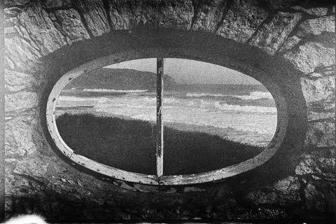 Ocean Waves Framed by an Oval Stone Opening Stock Photos
