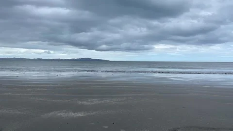 Ocean waves gently crashing on the sandy beach Stock Footage 250726965