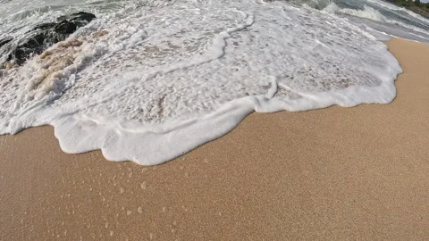 Ocean Waves Gently Crashing on Sandy Hawaiian Beach During a Cloudy Day Stock Footage 319341408