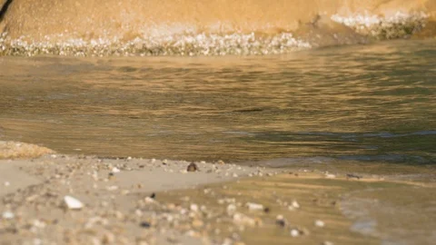 Ocean waves gently lapping on a sandy shore Stock Footage 94104927